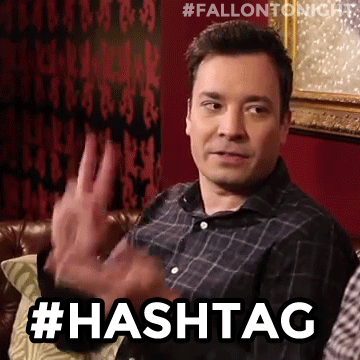 Gif the American show host Jimmy Fallon, doing the hashtag sign with his fingers 